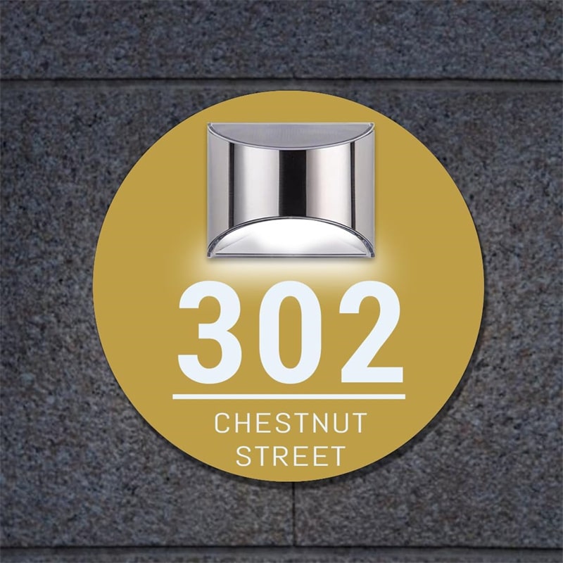 Round solar door plaque installed beside a front door