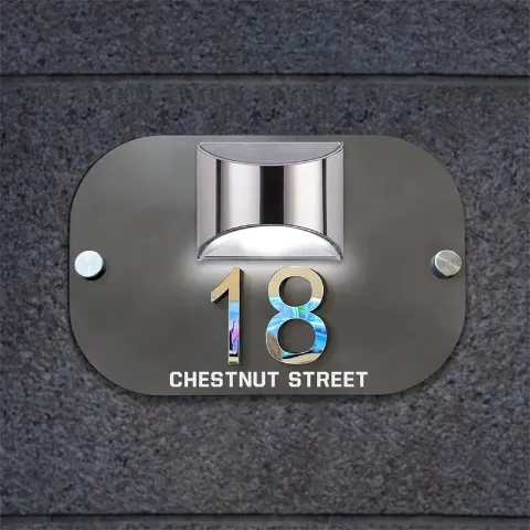 3D collage detail on the solar house number plaque