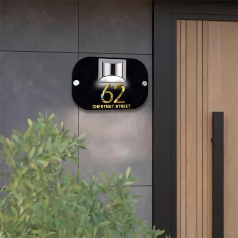 Solar 3D house number plaque lit up at night
