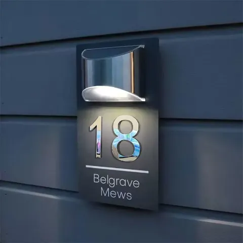 3D solar door plaque lit up at night
